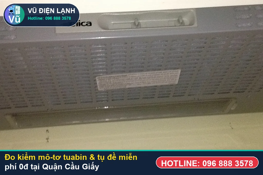 Thợ Vũ Điện Lạnh dùng đồng hồ vạn năng đo kiểm mô-tơ tuabin, tụ đề và công tắc khi sửa máy hút mùi tại cầu giấy ở KĐT Trung Hòa Nhân Chính